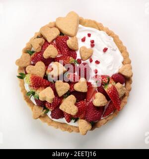 Fresh homemade fruit tart with raspberry and  strawberries on white background. Top view. Stock Photo
