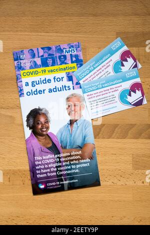 A NHS guide to Covid-19 vaccinations for older adults, with two Covid-19 vaccination record cards. Stock Photo