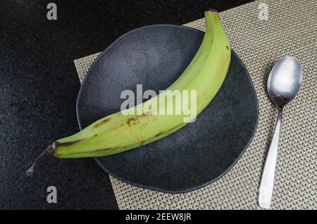 Beautiful black slate plate with banana Stock Photo