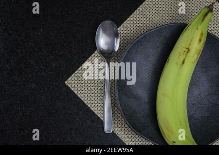 Beautiful black slate plate with banana Stock Photo