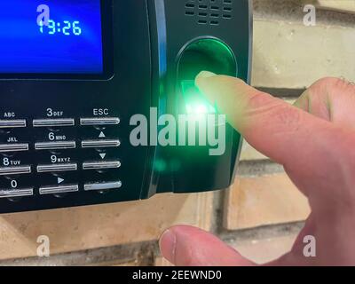 close up of a finger placed on an access control terminal with fingerprint, laser fingerprint scanner Stock Photo