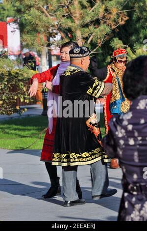 Dancers in Uyghur-style clothing at the city's Main Square. Zhangye-Gansu-China-1231 Stock Photo