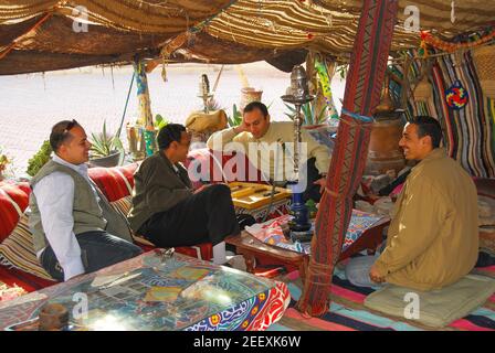 Men having tea in Bedouin tent, Taba Heights, Sinai Peninsula, Republic of Egypt Stock Photo