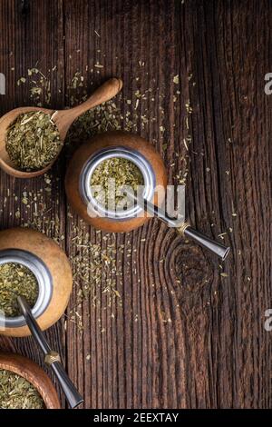 Healthy infused drink, classic Yerba Mate tea in a gourd with mobilla on wooden background Stock Photo