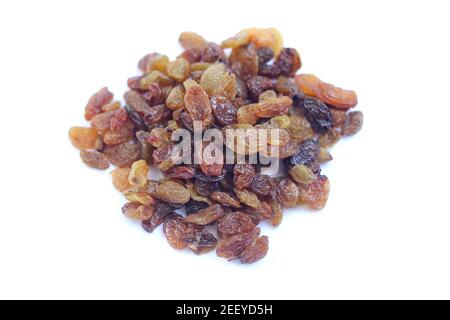 Selective focus on few raisins from pile of raisins in isolated white background Stock Photo
