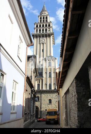 Bell tower of St. Nicholas Cathedral, main Roman Catholic Church of the city, side view in the perspective of the old town street, Bielsko-Biala Stock Photo