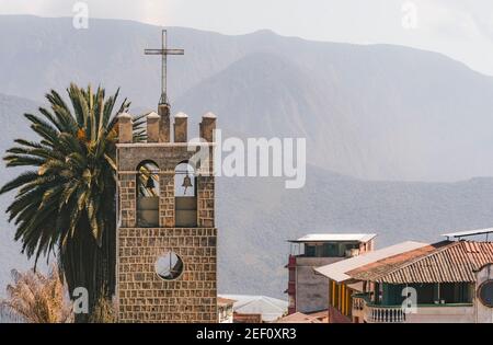 Church tower with palms and mountains in the background, in the downtown of Coroico, Bolivia. This tower is part o Stock Photo