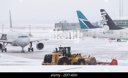 Mississauga, Canada. 16th Feb, 2021. A snow plow clears the snow at Toronto Pearson International Airport in Mississauga, Ontario, Canada, on Feb. 16, 2021. A winter storm hit the City of Toronto and surrounding areas on Tuesday. Credit: Zou Zheng/Xinhua/Alamy Live News Stock Photo