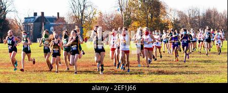 Bronx, New York, USA - 14 November 2020: High school girls starting a cross country running race wearing facemasks during coronavirus COVID-19 pandemi Stock Photo