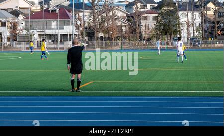 A football referee manages a game of football in Nerima City, Tokyo, Japan. Stock Photo