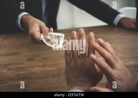 Businessman refusing money, Japanese yen bills - anti bribery and corruption concepts Stock Photo