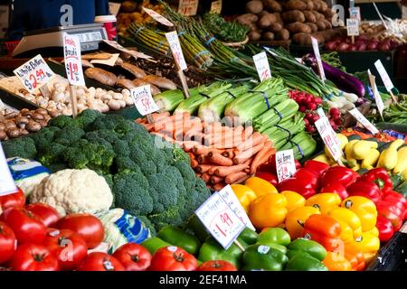 Vegetables for sale in the high stalls at the Pike Place Market. This farmer market is a famous sight in downtown of Seattle. Stock Photo