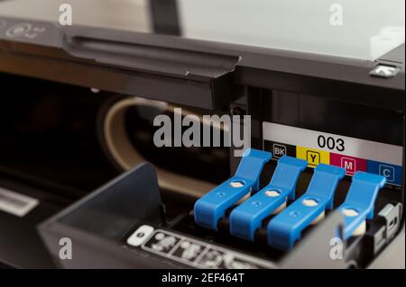 Replacement of CMYK set of ink cartridges in printer Stock Photo
