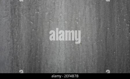 Old dark grey concrete wall with water stained background. Stock Photo