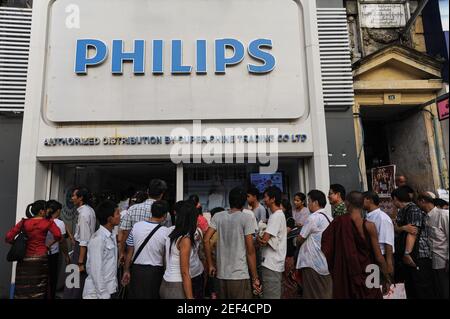 07.10.2013, Yangon, Asia - People queue up in front of a newly opened Philips retail store in downtown Yangon, the former capital city Rangoon. Stock Photo