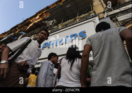 07.10.2013, Yangon, Asia - People queue up in front of a newly opened Philips retail store in downtown Yangon, the former capital city Rangoon. Stock Photo