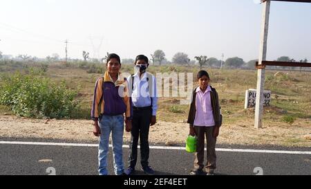 10 February 2021- Sikar, Jaipur, India. Cheerful school boy going school at school after lockdown open. Cheerful kid friends in happy mood and giving Stock Photo