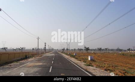 10 February 2021- Sikar, Jaipur, India. Black transportation road for factories and Industrial purposes. RIICO land reserve for heavy machinery profes Stock Photo