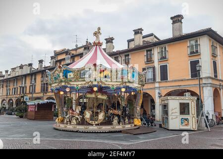 Colorful Carousel Attraction Ride With Wooden Horses in Brescia Stock Photo