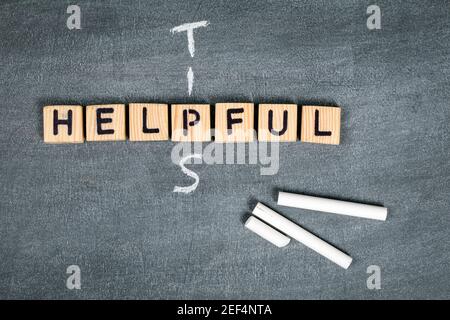Helpful Tips concept. Wooden alphabet letters on a gray chalk board. Stock Photo