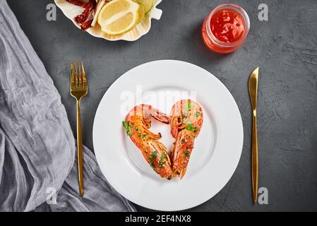 Two shrimps in shape of heart on plate, top view. Love concept Stock Photo