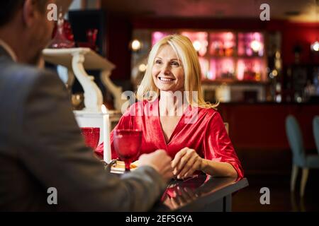 Cheerful woman enjoying dining out with her beloved man Stock Photo