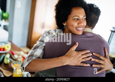 Happy black couple cooking and tasting healthy food in kitchen Stock Photo