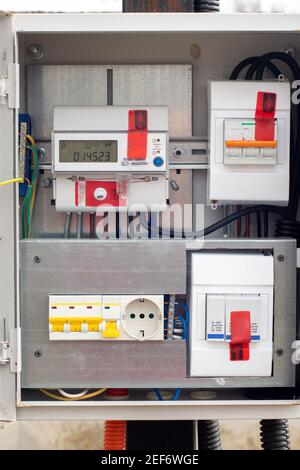 An introductory machine and an electric energy meter in a dashboard on a pole close-up Stock Photo