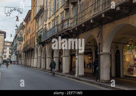 buildings with porticos, balcony and windows closed with wooden shutters Stock Photo