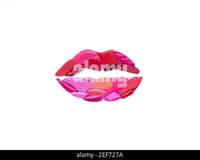 Red and pink lipstick smeared in the shape of lips. Isolated on white background Stock Photo