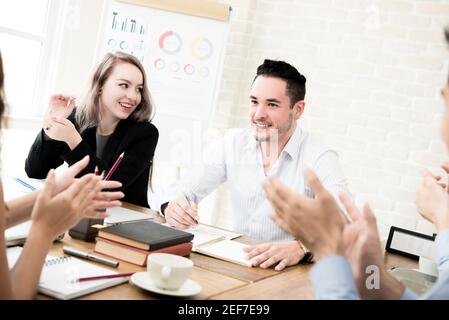Business people giving their colleague the applause at the meeting Stock Photo