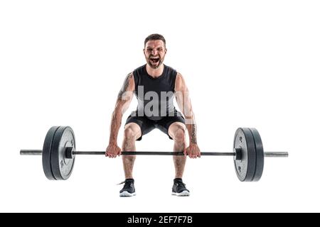 Aggressive bearded strong muscular Man in sportswear Doing A Deadlift Exercise. Full length studio shot isolated on white. Stock Photo