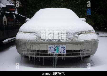 Frozen car in a parking lot in Lake Oswego, Oregon, on February 13, 2021, after snow and freezing rain hits Portland metro area. Stock Photo