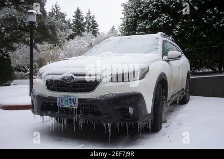 Frozen car in a parking lot in Lake Oswego, Oregon, on February 13, 2021, after snow and freezing rain hits Portland metro area. Stock Photo
