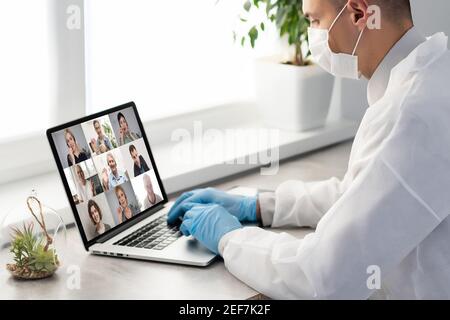 Doctor Having Video Conference On Laptop With Colleagues Stock Photo