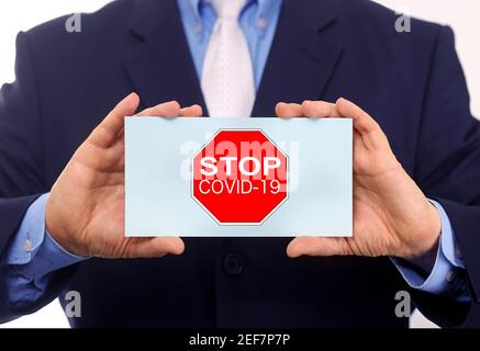 Business man hold paper stop coronavirus text on it Stock Photo