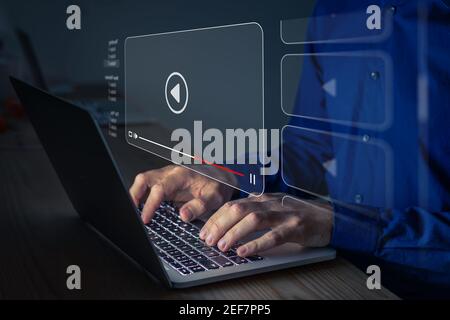 Video streaming on internet. Person watching online movie or TV series on laptop computer screen. Concept about subscription based live digital stream Stock Photo