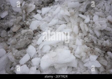 Close up of dirty ice and snow removed and piled up by the roadside. Stock Photo