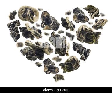 Dried Oolong tea in the shape of a heart on a white background Stock Photo