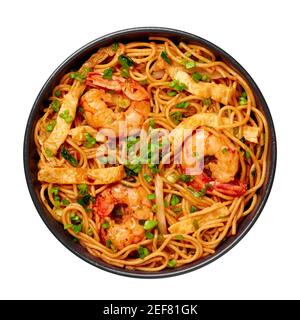 Mie Goreng in black bowl isolated on white. Indonesian cuisine prawn noodles and vegetables stir fired dish. Asian food. Stock Photo