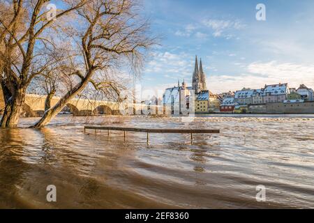 Flood of the river Danube in winter 2021 in Regensburg with view of the cathedral the old town and flooded promenade and the stone bridge, Germany Stock Photo