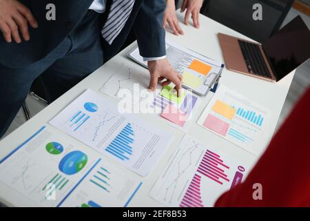 Businessmen discussing business figures at their desk Stock Photo