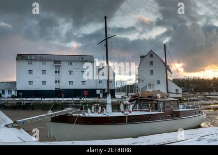 WOODBRIDGE, SUFFOLK, UK - FEBRUARY 11, 2010:  View of the Tide Mill at dawn seen over boat tied up on the River Deben beside the slipway Stock Photo