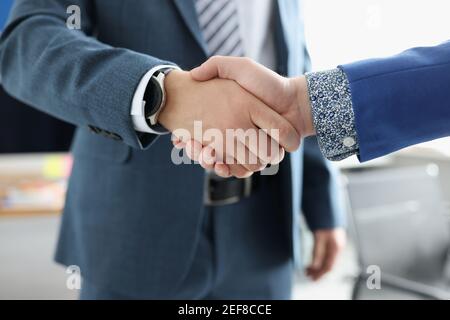 Two businessmen are shaking hands friendly closeup Stock Photo