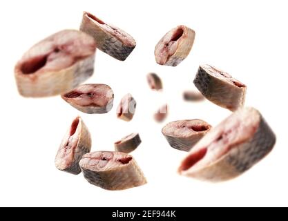 Pieces of fresh fish levitate on a white background Stock Photo