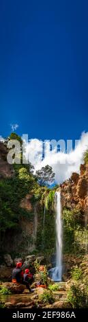 Unrecognizable people enjoy waterfall descent with text space Stock Photo