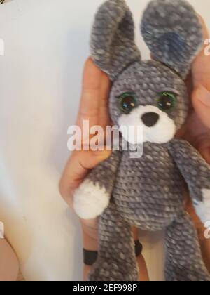 Close-up of a crocheted plush rabbit on a white background Stock Photo