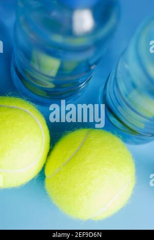 High angle view of two tennis balls with two water bottles Stock Photo