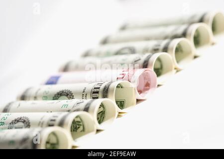 Rolls of US paper currency with European union euro note Stock Photo