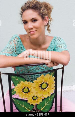 Portrait of a teenage girl sitting on a chair Stock Photo